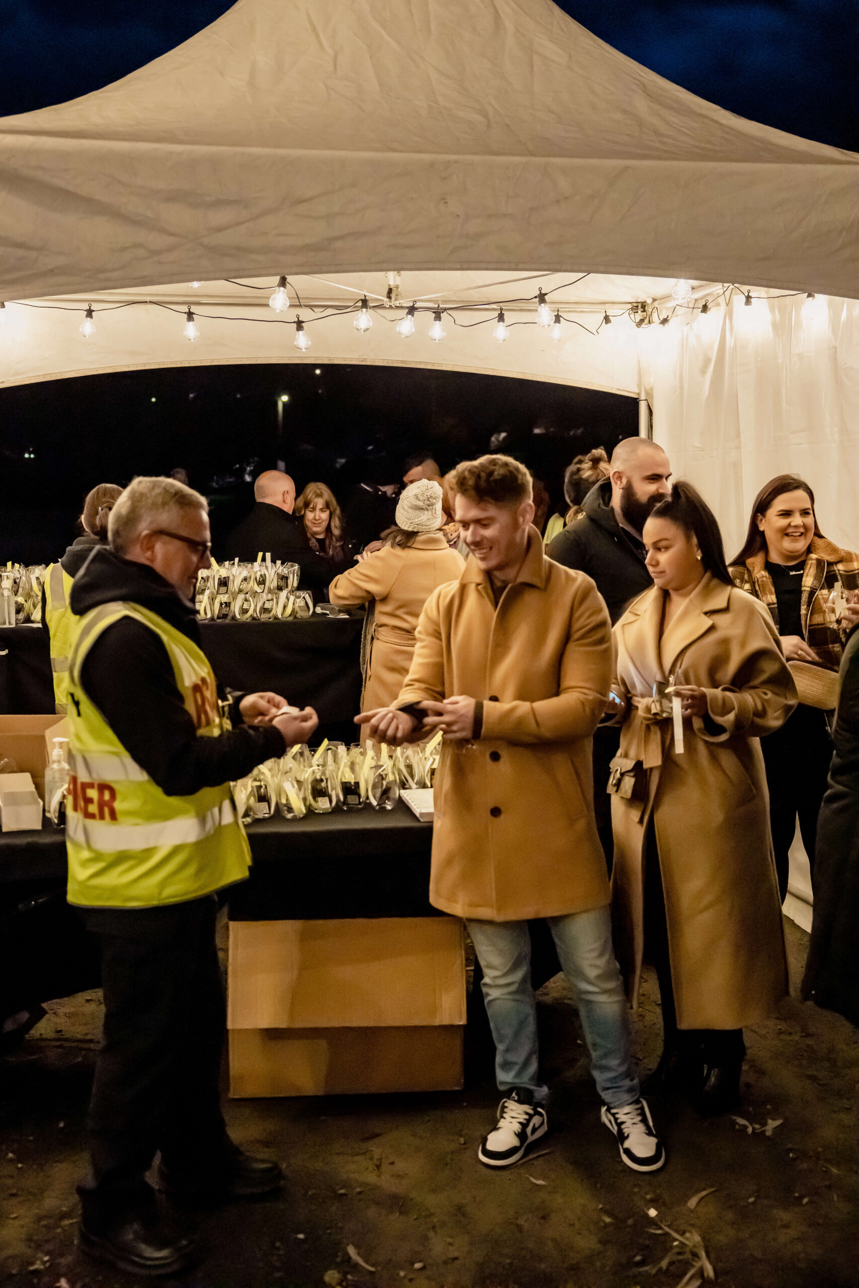 Security welcomes attendees to Fireside Winter Twilight Market