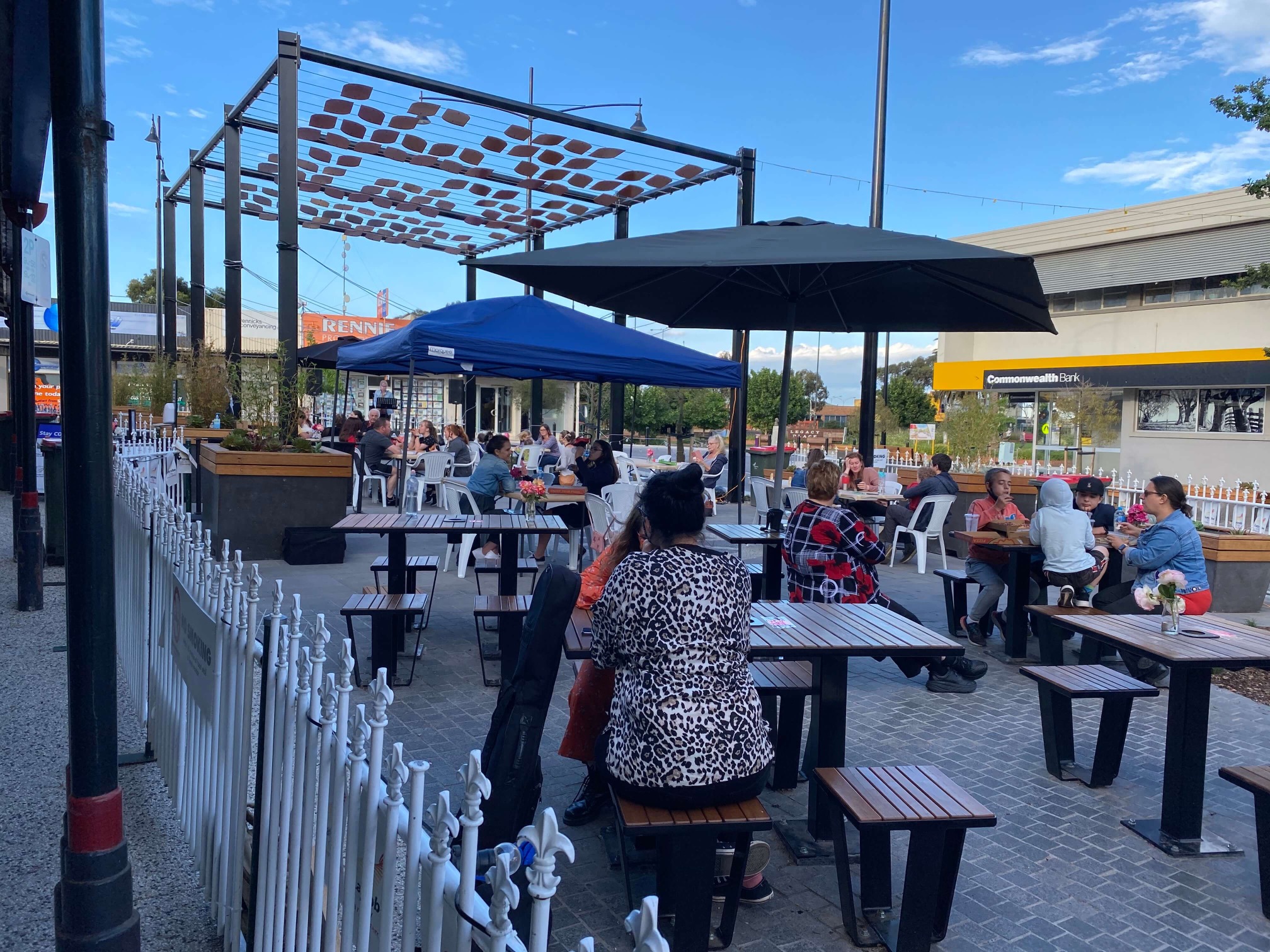 People sit at tables along Tarwin Street during the Latrobe City Council Outdoor Dining Initiative October 2020