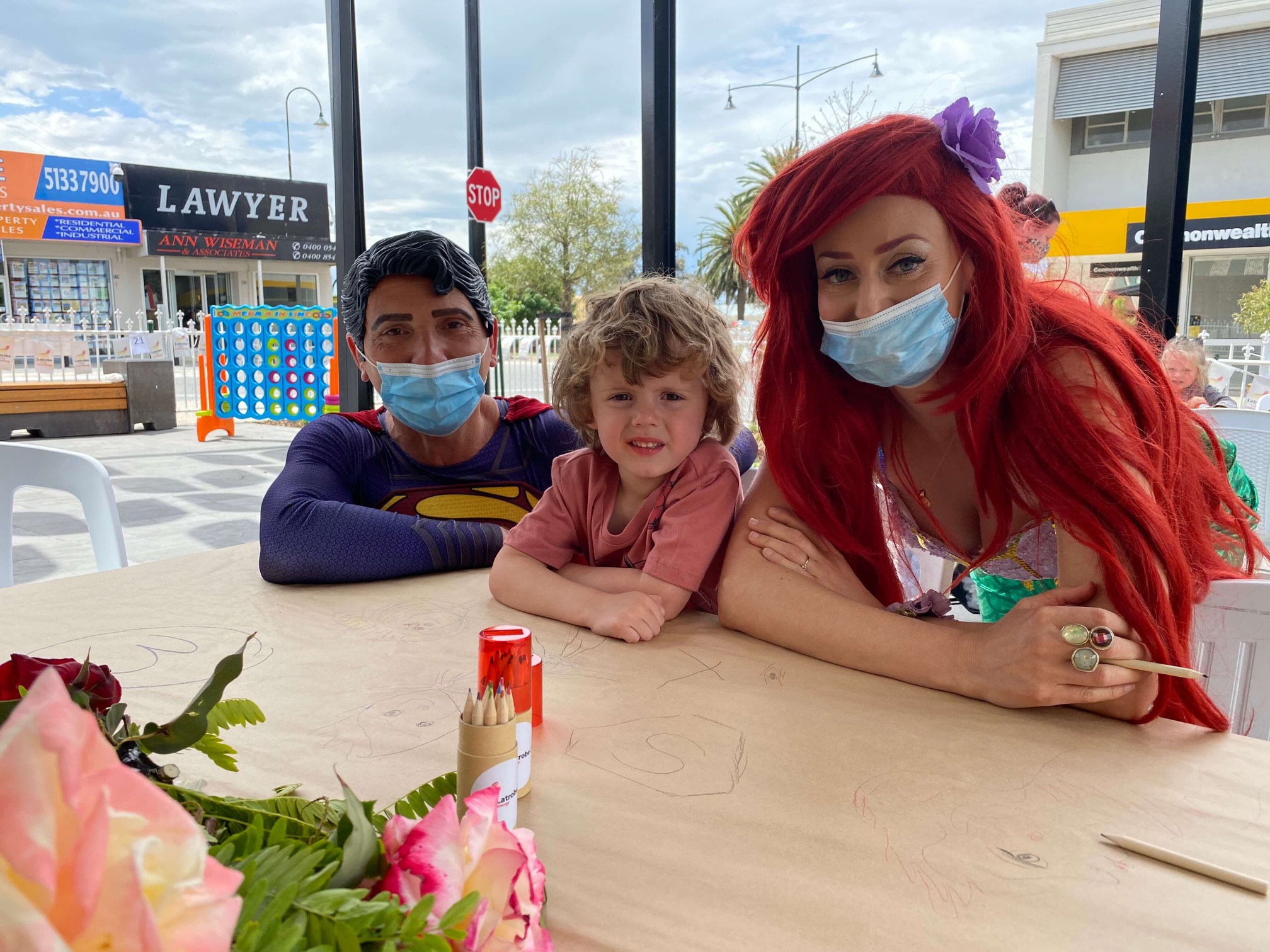 Child poses with Superman and Aeriel at Latrobe City Council Outdoor Dining Initiative October 2020